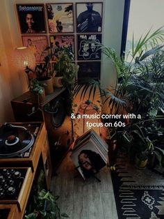 a room with plants and pictures on the wall, and a record player in the corner