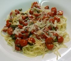 a white plate topped with pasta covered in sauce