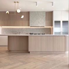 an empty kitchen with wooden floors and cabinets