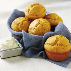 some muffins are sitting in a blue cloth