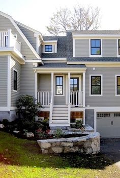 an exterior color scheme for a house with white trim and gray siding, including the front door