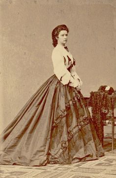 an old photo of a woman in a long dress