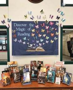 a table topped with lots of books and butterflies