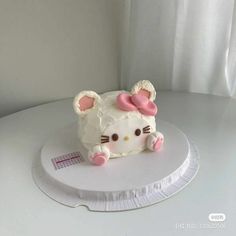 a hello kitty cake sitting on top of a white plate