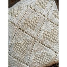 a white knitted blanket sitting on top of a table