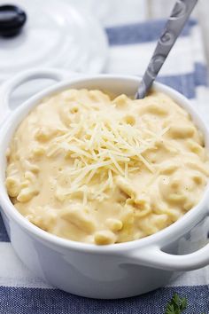 a bowl filled with macaroni and cheese on top of a blue and white towel