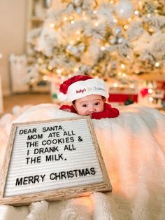 a baby in a santa hat is holding a sign that says dear santa from the cookies and i drank all the milk