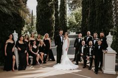 a group of people in formal wear posing for a photo