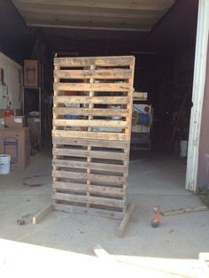 a large wooden pallet sitting in the middle of a garage next to some boxes