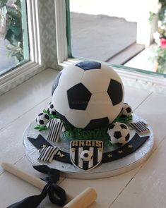 a soccer themed cake is sitting on a table