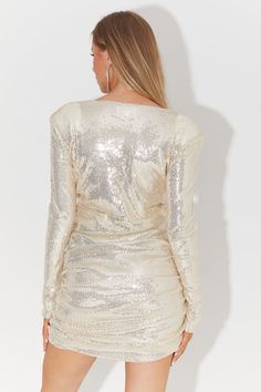 Shine like a star in this Sequin Wrap Mini Dress from Unique21. This dazzling dress is adorned with sequins that catch the light from every angle, ensuring you stand out on any occasion. The wrap-style design is not only trendy but also incredibly flattering, allowing you to adjust the fit to your liking. With its short length and long sleeves, it strikes the perfect balance between sexy and sophisticated, making it an ideal choice for a night of dancing and celebration. Fitted V-neck Sequin Dress For Festive Occasions, Long Sleeve Shimmer Dresses For Prom, Sparkling Sequin V-neck Fitted Dress, Fitted Sequin Mini Dress, Glamorous Long Sleeve Shimmer Dress, Long Sleeve Dressy Sequin Dress For Holiday Party, Dressy Long Sleeve Sequin Dress For Holiday Party, Shiny V-neck Party Dresses, Fitted V-neck Sequin Dress With Glitter