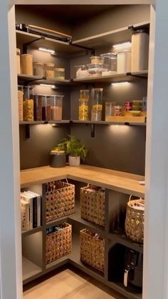 an open pantry filled with lots of food and storage bins on the side of it