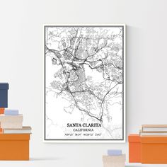 a black and white map of santa clarita, california on a wall above books