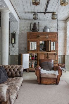 a living room with two couches, a chair and a bookcase in it