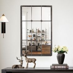 a deer statue sitting on top of a wooden table