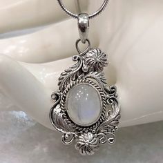 Simply Beautiful And Perfect For Any Color Outfit! Gorgeous Crafted And Detailed Filigree (Scrolls, Florals, Tendrils) Sterling Silver Pendant Featuring A Large Jelly Bean-Like Rainbow Moonstone. Stone Has A Pale Blue Sheen And Near Transparent Look. Pendant Measures 1.5” Long Marked 925 Comes With 20” Italian Sterling Silver Snake Chain Intricate Design Moonstone Jewelry, Exquisite Engraved White Jewelry, Exquisite White Engraved Jewelry, Exquisite Silver Oval Pendant Jewelry, Elegant Engraved Moonstone Jewelry, Silver Engraved Moonstone Necklace, Silver Oval Pendant With Intricate Design, Intricate Moonstone Jewelry For Gift, Intricate Moonstone Jewelry As A Gift