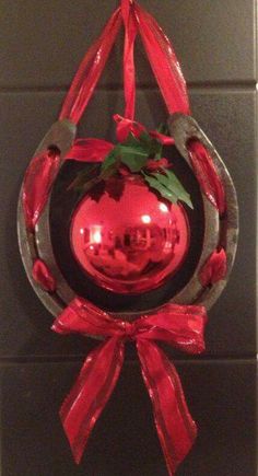 a red christmas ornament hanging from a wall