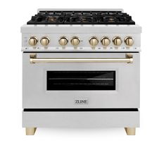 a white stove with gold knobs on it's burners and two oven doors