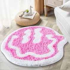 a bathroom rug with pink and white designs on it