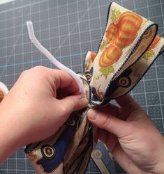 someone is making something out of fabric with scissors