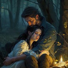 a man and woman sitting next to each other in the woods with candles on them