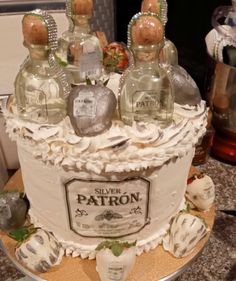 there is a cake made to look like a bottle of patron on top of it