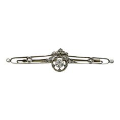 This is part of Chairish’s Fine Jewelry assortment.  This diamond encrusted bar pin dates to 1900’s pre-revolutionary Russia. The center Old European Cut diamond is bezel set with beautiful milgrain work around it. Set in a larger circle element, the diamond is surrounded by cut outs in the shape of a flower with five Rose Cut diamonds bead set into the corners of its petals. This central element is flanked by Rose Cut and Single Cut diamonds along the bar and the pin is topped with a crown moti Classic White Gold Brooch For Formal Occasions, Classic White Gold Brooches For Formal Occasions, Classic Diamond Brooches For Anniversary, Classic Diamond Brooch For Formal Occasions, Classic Brooches With Rose Cut Diamonds, Classic Rose Cut Diamond Brooches, Classic White Gold Brooches With 17 Jewels, Classic White Gold Brooches With Single Cut Diamonds, Classic Brooches With Rose Cut Diamonds For Anniversary