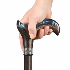 a hand holding an old fashioned walking stick with the handle extended to it's side