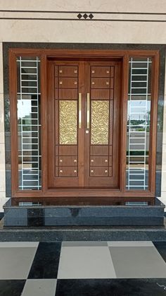 the front door to a building with two glass doors on each side and black and white checkered floor