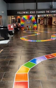 a colorful walkway in the middle of a building with an advertisement on it that says following jesus changes the game