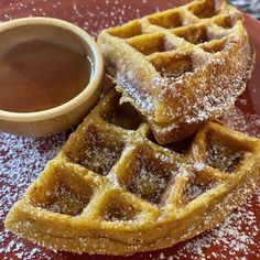 two waffles stacked on top of each other next to a cup of coffee