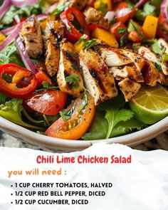 a salad with grilled chicken and vegetables on it