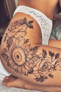 a woman with sunflowers and roses on her thigh