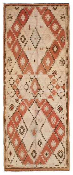 an orange and white rug with geometric designs on the bottom, two rows of diamonds