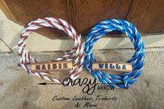 two braided bracelets sitting next to each other on a door mat with name tags