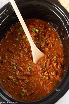 a slow cooker filled with chili and beans