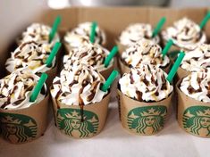 starbucks cupcakes with whipped cream and chocolate sprinkles are arranged in a cardboard box