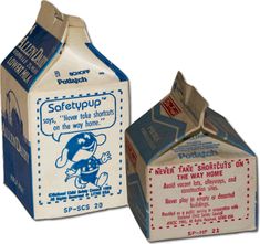 two milk boxes with labels on them sitting side by side