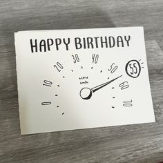 a happy birthday card with a speedometer on the front, and an hour handwritten in black ink