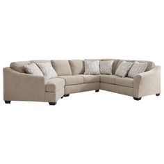 a large sectional couch with pillows on the top and bottom corner, in front of a white background