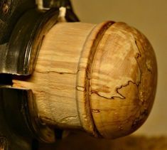 a close up view of a wooden object with metal fittings and wood grain on it