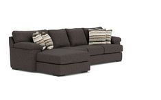 a sectional sofa with pillows on it