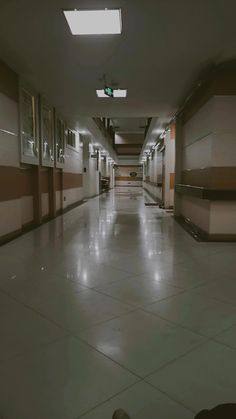 an empty hospital hallway with no people or medical supplies on the floor and one person laying down