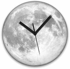 a clock with the moon in the background