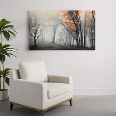 a white chair sitting in front of a painting on the wall next to a potted plant