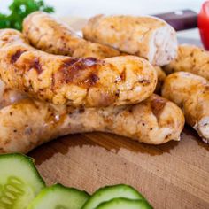 several sausages and cucumbers on a cutting board