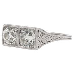 an antique style diamond ring with filigrees