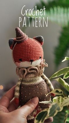 a hand holding a small knitted animal in front of a plant with the words crochet pattern on it