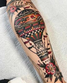 a person with a hot air balloon tattoo on their arm