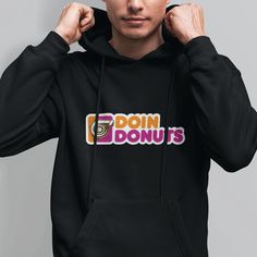 a man in a black hoodie with the words donuts on it